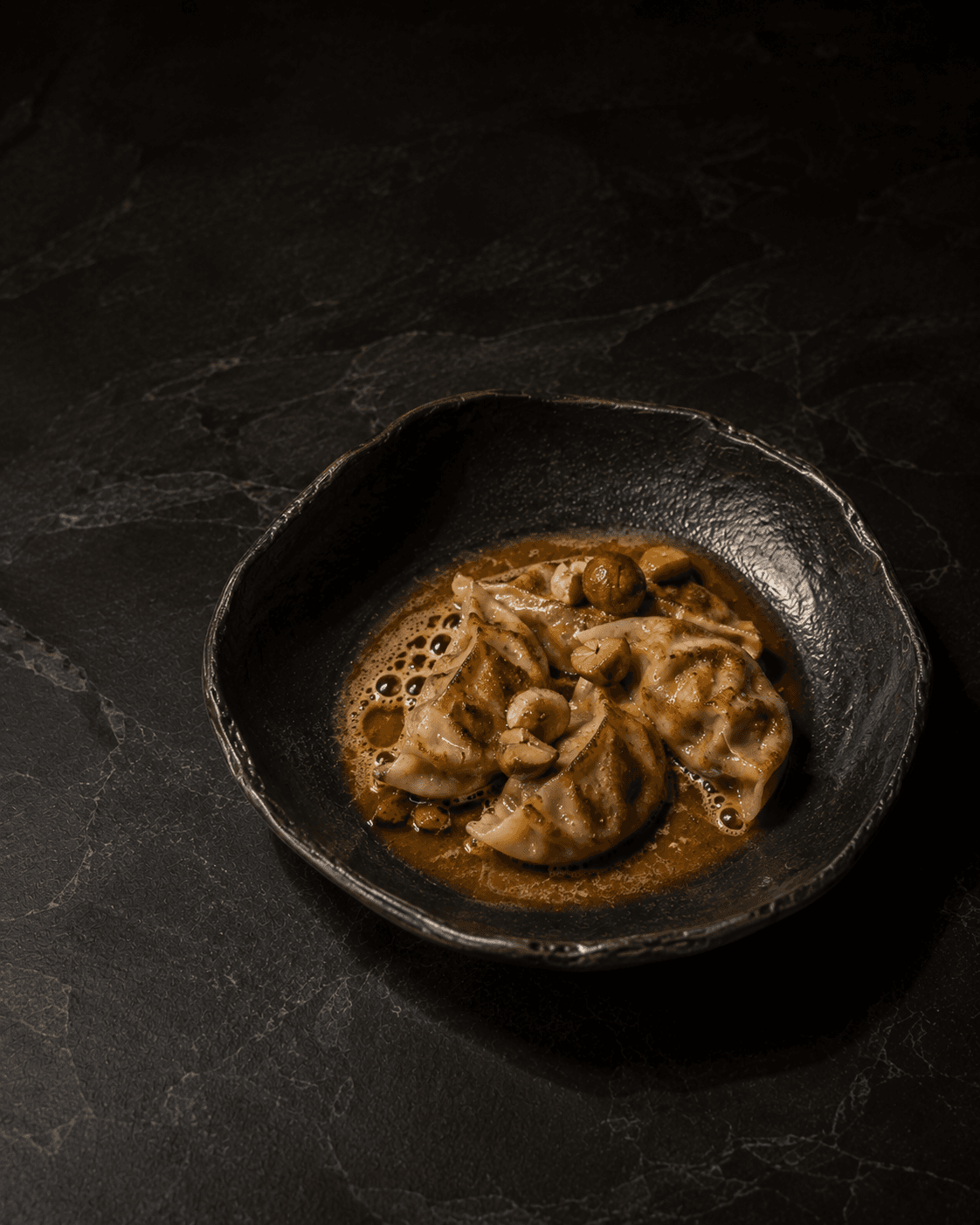 Plate of Chestnut Mandu, Brown Butter, Aged Soy