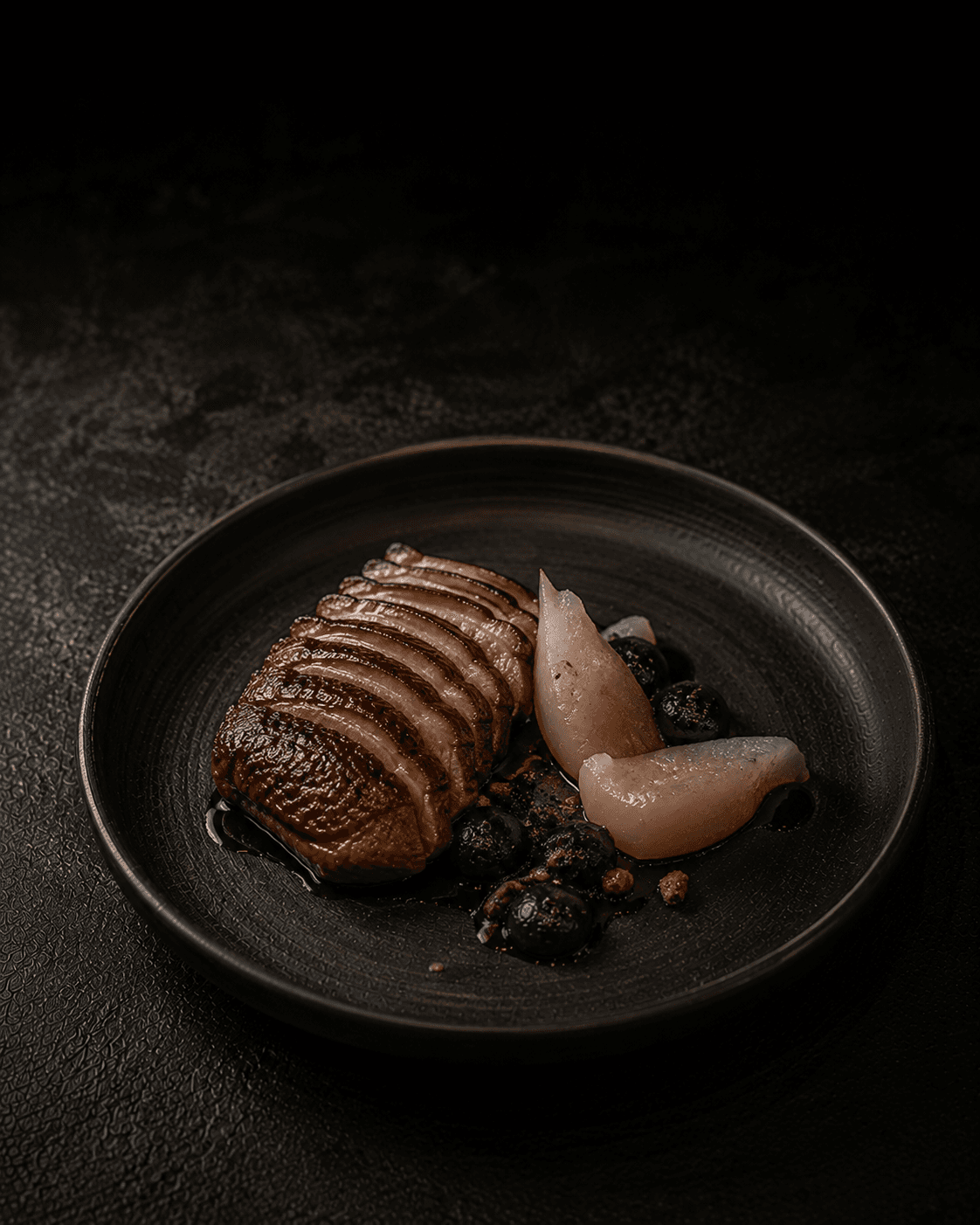 Plate of Dry-Aged Duck, Frozen Pear, Black Garlic