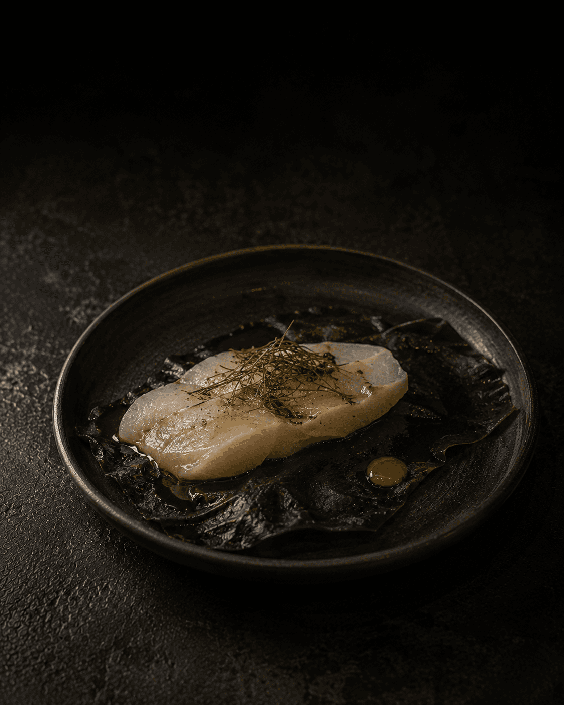 Plate of Kelp-Cured Halibut, Green Plum, Radish Oil