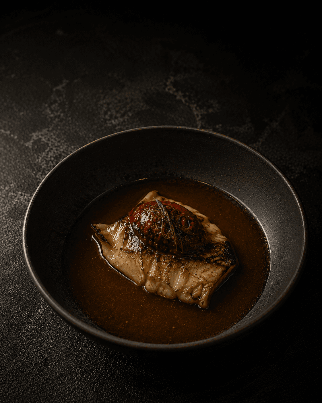Plate of Slow Monkfish, Gochujang Caramel, Bone Broth
